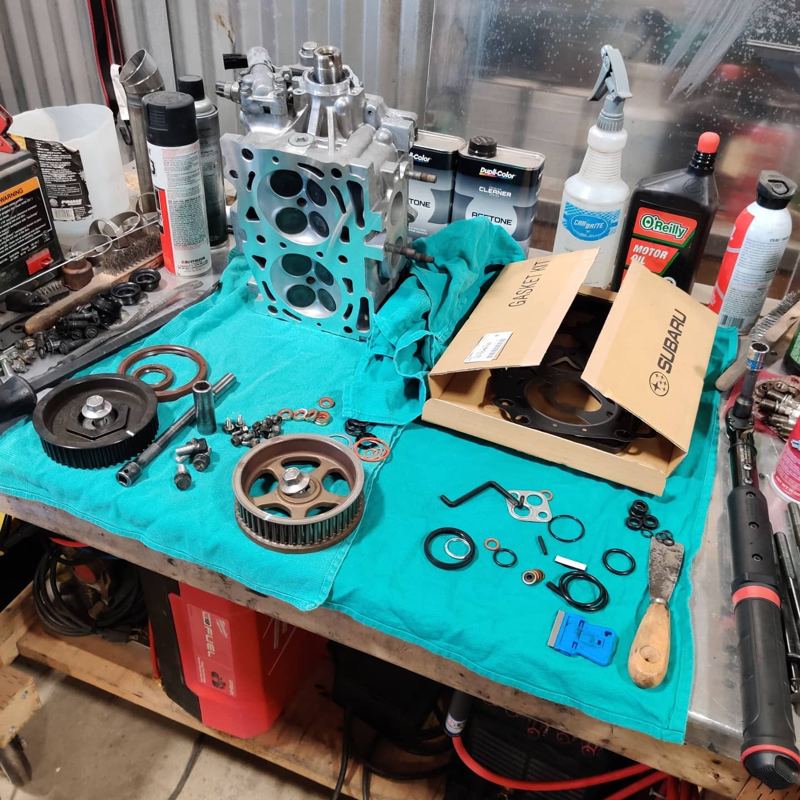 EJ parts, timing gears and gaskets laid out on a shop towel