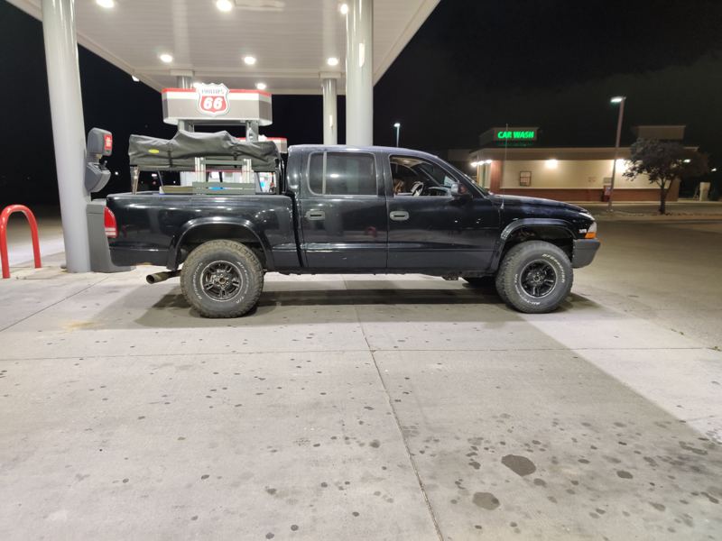 Black Dakota with the finished tent rack, parked at night